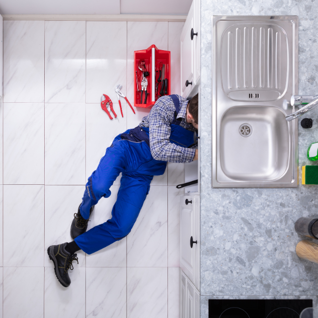 plumber fixing residential sink