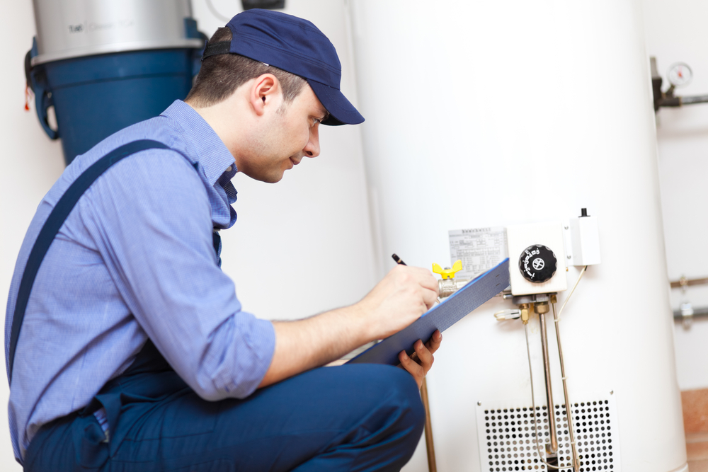 man working on a water heater