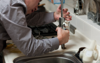 residential plumber fixing a sink